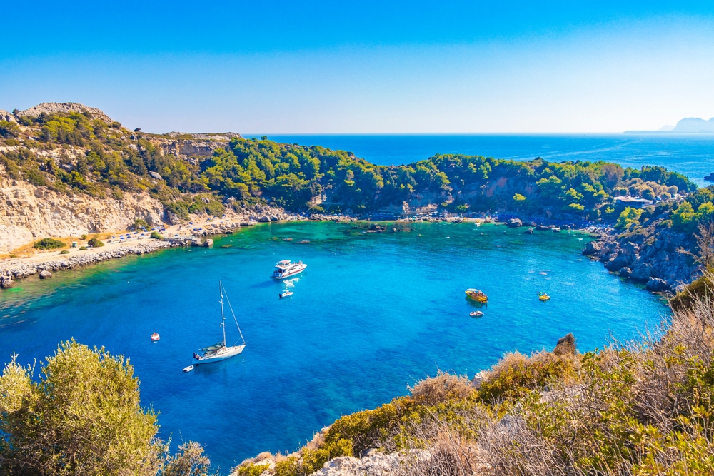 Turkost vatten i Anthony Quinn Bay vid Faliraki på Rhodos