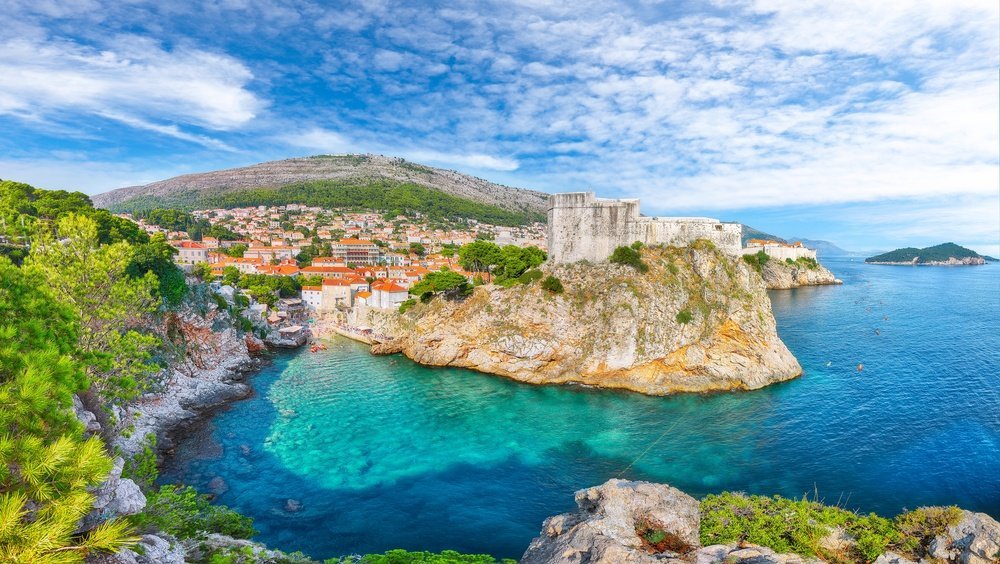Kajaker på havet under stadsmuren och Bokar-fästningen i Dubrovnik